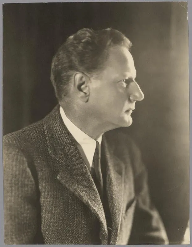 A black and white side portrait of Dard Hunter in a suit and tie